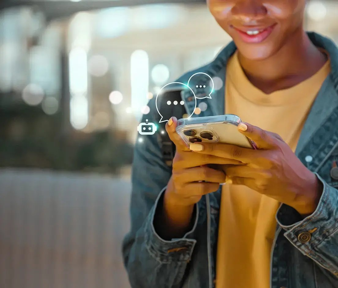 Teenager typing on his iphone.